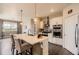 Contemporary kitchen with a central island, modern appliances, and open living area at 8953 Falcon St, Firestone, CO 80504