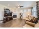 Bright living room with a fireplace, hardwood floors, and neutral colors, perfect for relaxation at 8953 Falcon St, Firestone, CO 80504