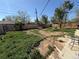 Expansive backyard featuring a wooden fence, mature trees, and ample space for outdoor activities at 1151 Revere St, Aurora, CO 80011