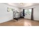 Bedroom with wooden floors featuring a bunk bed and two windows for natural light at 1151 Revere St, Aurora, CO 80011