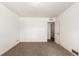 Simple bedroom with neutral carpet, white walls, and access to an adjacent room at 1151 Revere St, Aurora, CO 80011