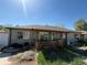 Single-story home featuring a covered front porch with a fence and a quaint exterior in need of yard work at 1151 Revere St, Aurora, CO 80011