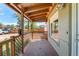 View of the home's covered front porch featuring a latticework fence and a brick exterior at 1151 Revere St, Aurora, CO 80011