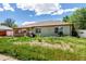 Well-maintained single-story house with a cozy front porch and easy to care for landscaping and blue skies at 1151 Revere St, Aurora, CO 80011