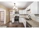 Bright kitchen featuring white cabinets, stainless steel oven, and stylish tile backsplash at 1151 Revere St, Aurora, CO 80011