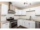 Modern kitchen with white cabinets, stainless steel appliances, and granite countertops at 1151 Revere St, Aurora, CO 80011