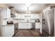 Well-lit kitchen featuring white cabinets, stainless steel appliances, and tile backsplash at 1151 Revere St, Aurora, CO 80011