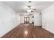 Spacious living room featuring hardwood floors, ceiling fans, and a set of french doors at 1151 Revere St, Aurora, CO 80011