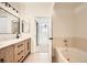 Bright bathroom features a soaking tub and double vanity with modern fixtures and finishes at 9079 E Panorama Cir # 419, Englewood, CO 80112