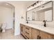 Modern bathroom with double vanity, wooden cabinets, and a framed mirror at 9079 E Panorama Cir # 419, Englewood, CO 80112