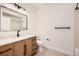 A well-lit bathroom features a vanity with cabinets and a shower with modern fixtures at 9079 E Panorama Cir # 419, Englewood, CO 80112