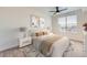 Cozy bedroom with a ceiling fan, a large window for natural light, and neutral decor at 9079 E Panorama Cir # 419, Englewood, CO 80112