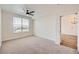 Bright bedroom with ceiling fan and natural light from the large window with open blinds at 9079 E Panorama Cir # 419, Englewood, CO 80112