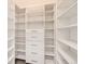 Spacious walk-in closet features built-in shelving and drawers, providing ample storage at 9079 E Panorama Cir # 419, Englewood, CO 80112