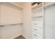 Walk-in closet features built-in shelving and drawers for organized storage at 9079 E Panorama Cir # 419, Englewood, CO 80112