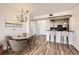 Open-concept dining area flows into the kitchen with modern chandelier and hardwood flooring at 9079 E Panorama Cir # 419, Englewood, CO 80112