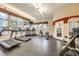 Well-equipped fitness center with modern exercise machines and large windows overlooking trees at 9079 E Panorama Cir # 419, Englewood, CO 80112