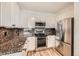 Well-lit kitchen boasts stainless steel appliances, granite countertops, and ample cabinet space at 9079 E Panorama Cir # 419, Englewood, CO 80112