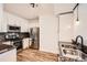 Modern kitchen featuring stainless steel appliances, granite countertops, and white cabinetry at 9079 E Panorama Cir # 419, Englewood, CO 80112