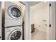 Efficient laundry room with stackable washer and dryer adjacent to a bathroom at 9079 E Panorama Cir # 419, Englewood, CO 80112