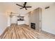 Spacious living room with fireplace, ceiling fan, and hardwood floors open to the kitchen area at 9079 E Panorama Cir # 419, Englewood, CO 80112