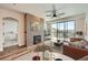 Bright living room featuring a modern fireplace, a ceiling fan, and a sliding door to a balcony at 9079 E Panorama Cir # 419, Englewood, CO 80112