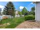 Expansive green backyard with a white fence, mature trees, and manicured landscaping at 1160 S Fultondale Ct, Aurora, CO 80018