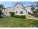 Low angle view of the home's yard with a white fence, landscaping, patio and exterior at 1160 S Fultondale Ct, Aurora, CO 80018