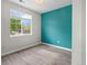 Bright bedroom with laminate floors, a blue accent wall and a large window overlooking the neighborhood at 1160 S Fultondale Ct, Aurora, CO 80018