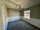 Neutral bedroom with carpeted floors, updated ceiling fan and large window at 1160 S Fultondale Ct, Aurora, CO 80018
