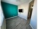 Bedroom featuring a modern color scheme, wood floors, and tv at 1160 S Fultondale Ct, Aurora, CO 80018