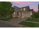Charming two-story home with brick accents, a well-manicured lawn, and a two-car garage under a beautiful sunset at 1160 S Fultondale Ct, Aurora, CO 80018