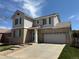 Attractive two-story home with tan brick, gray siding, and a two car garage at 1160 S Fultondale Ct, Aurora, CO 80018