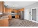 Functional kitchen featuring stainless steel appliances, wooden cabinets, and easy access doors at 1160 S Fultondale Ct, Aurora, CO 80018