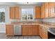 Convenient kitchen setup with stainless steel dishwasher, ample cabinet space, and a functional layout at 1160 S Fultondale Ct, Aurora, CO 80018