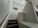 Carpeted staircase leads upstairs with a modern light fixture at 1160 S Fultondale Ct, Aurora, CO 80018