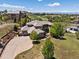Stunning aerial view of an expansive estate with lush landscaping and a winding driveway at 6995 S Ensenada St, Aurora, CO 80016