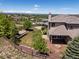 Aerial view of a luxury home, beautiful landscaping, and backyard fire pit at 6995 S Ensenada St, Aurora, CO 80016