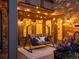 Cozy covered patio with porch swing, stone accent wall, and decorative string lights at 6995 S Ensenada St, Aurora, CO 80016