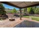 Backyard patio with built-in fire pit and landscaping featuring tiered retaining wall at 6995 S Ensenada St, Aurora, CO 80016