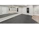 Spacious mirrored basement room featuring updated carpets and recessed lighting at 6995 S Ensenada St, Aurora, CO 80016