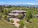 Sprawling home with a three-car garage, beautiful landscaping, and mountain views in the distance at 6995 S Ensenada St, Aurora, CO 80016