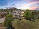 Inviting two-story home with stone accents, professional landscaping and an expansive lawn at sunset at 6995 S Ensenada St, Aurora, CO 80016