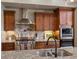 Close up of a gourmet kitchen featuring a large island with seating, stainless steel appliances, and custom cabinetry at 6995 S Ensenada St, Aurora, CO 80016