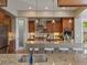 Stylish kitchen showcasing wood cabinets, stainless steel appliances, granite counters, and an island with seating at 6995 S Ensenada St, Aurora, CO 80016