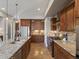 Gourmet kitchen featuring a large island with seating, stainless steel appliances, and custom cabinetry at 6995 S Ensenada St, Aurora, CO 80016