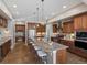 Gourmet kitchen featuring a large island with seating, stainless steel appliances, and wood cabinets at 6995 S Ensenada St, Aurora, CO 80016