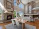 Open-concept space with fireplace, hardwood floors, large windows, seamlessly blending living and dining areas at 6995 S Ensenada St, Aurora, CO 80016