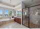 Well-lit bathroom with double vanity, a soaking tub and walk-in shower with glass door at 6995 S Ensenada St, Aurora, CO 80016