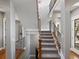 Elegant staircase with wrought iron railings and wood accents leading to the upper level at 6995 S Ensenada St, Aurora, CO 80016